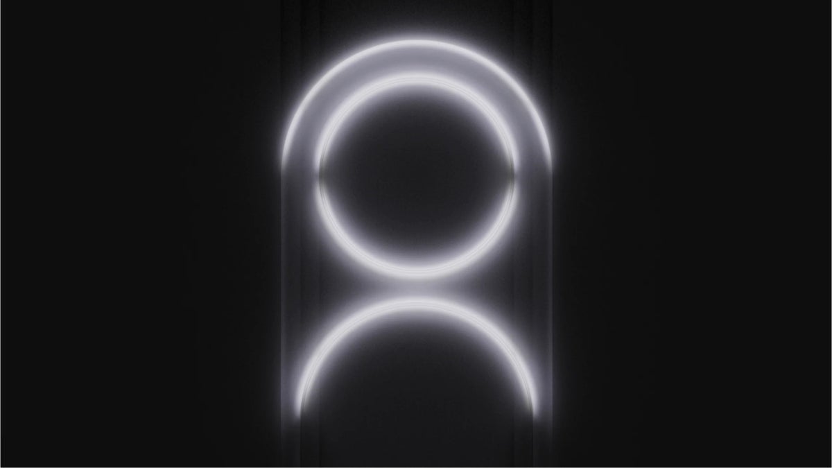Two white glowing circles next to each other on a black background.