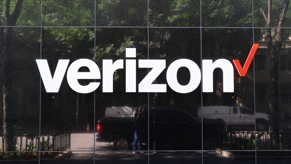 Verizon logo is displayed on a glass building.
