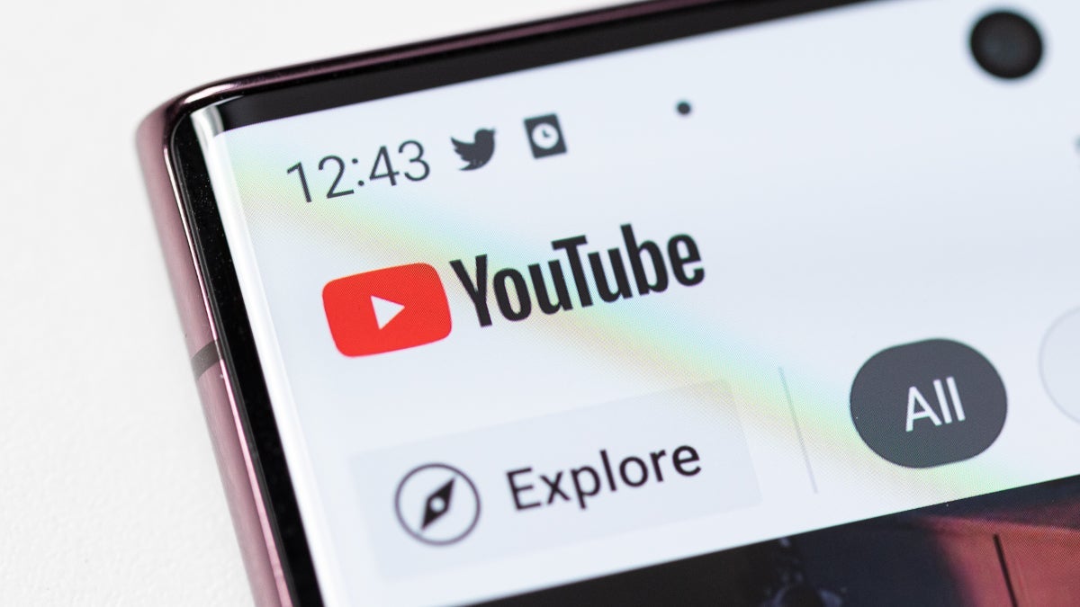 The corner of the Android YouTube app appears on the front screen of an Android handset.